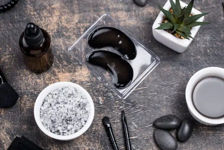 Gua Sha facial massage: Luxury spa accessories including salt, massage stones, and eye patches