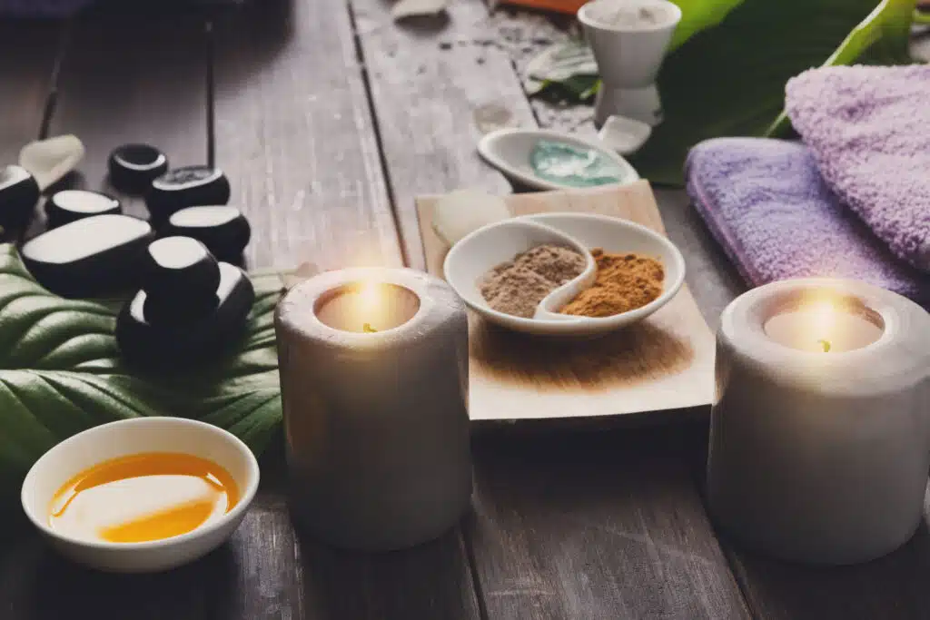 Thai spa rituals: Calming spa setup featuring candles, essential oils, and natural herbal powders in a serene Phuket setting.