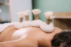 Thai herbal massage in Phuket: Herbal poultice massage for relaxation.