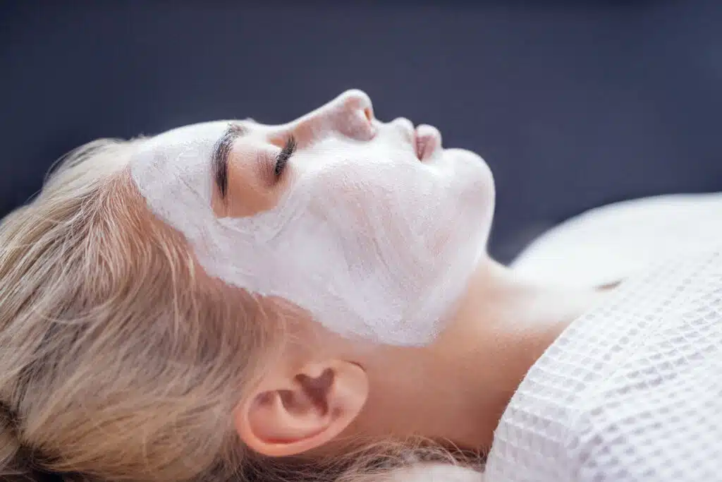 after-sun recovery in Phuket: Woman receiving a calming after sun facial treatment