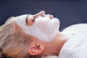 after-sun recovery in Phuket: Woman receiving a calming after sun facial treatment