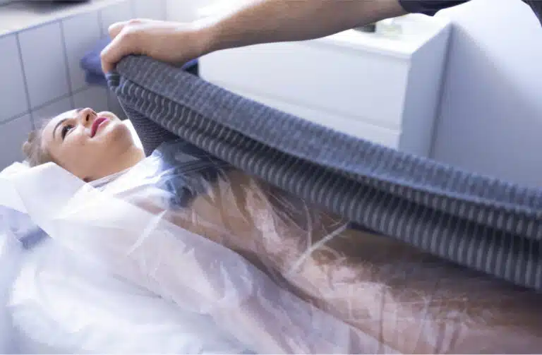 body wraps in Phuket: Woman receiving a professional spa body wrap treatment