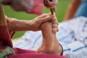 foot massage in Phuket: Foot massage using reflexology wooden therapy stick