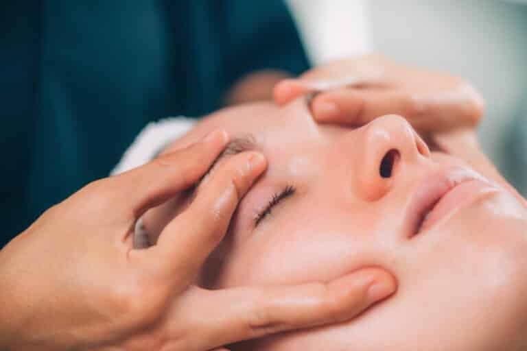 facial treatments in Phuket: Therapist performing a relaxing facial treatment