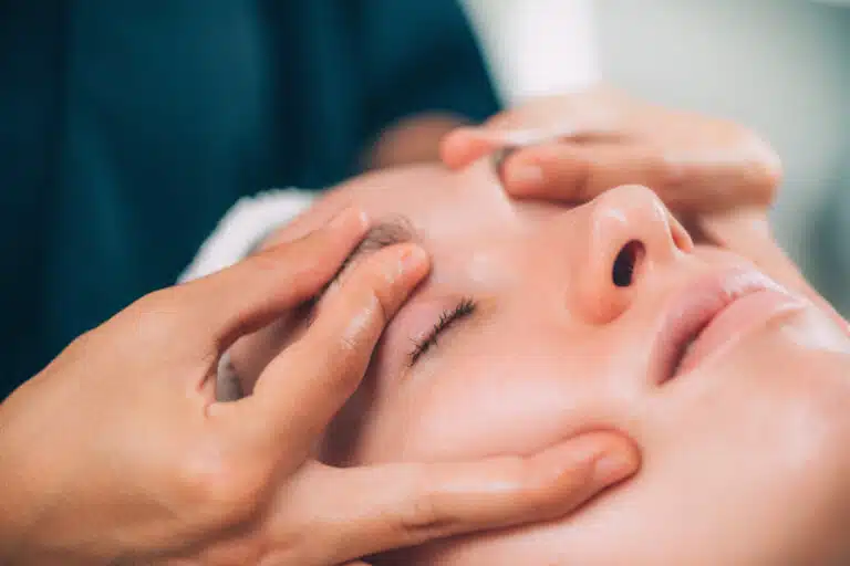 facial treatments in Phuket: Therapist performing a relaxing facial treatment