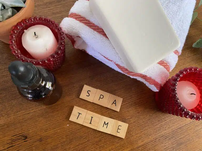 when to book spa treatment in Phuket: Spa essentials with candles, soap, oil, and towel set